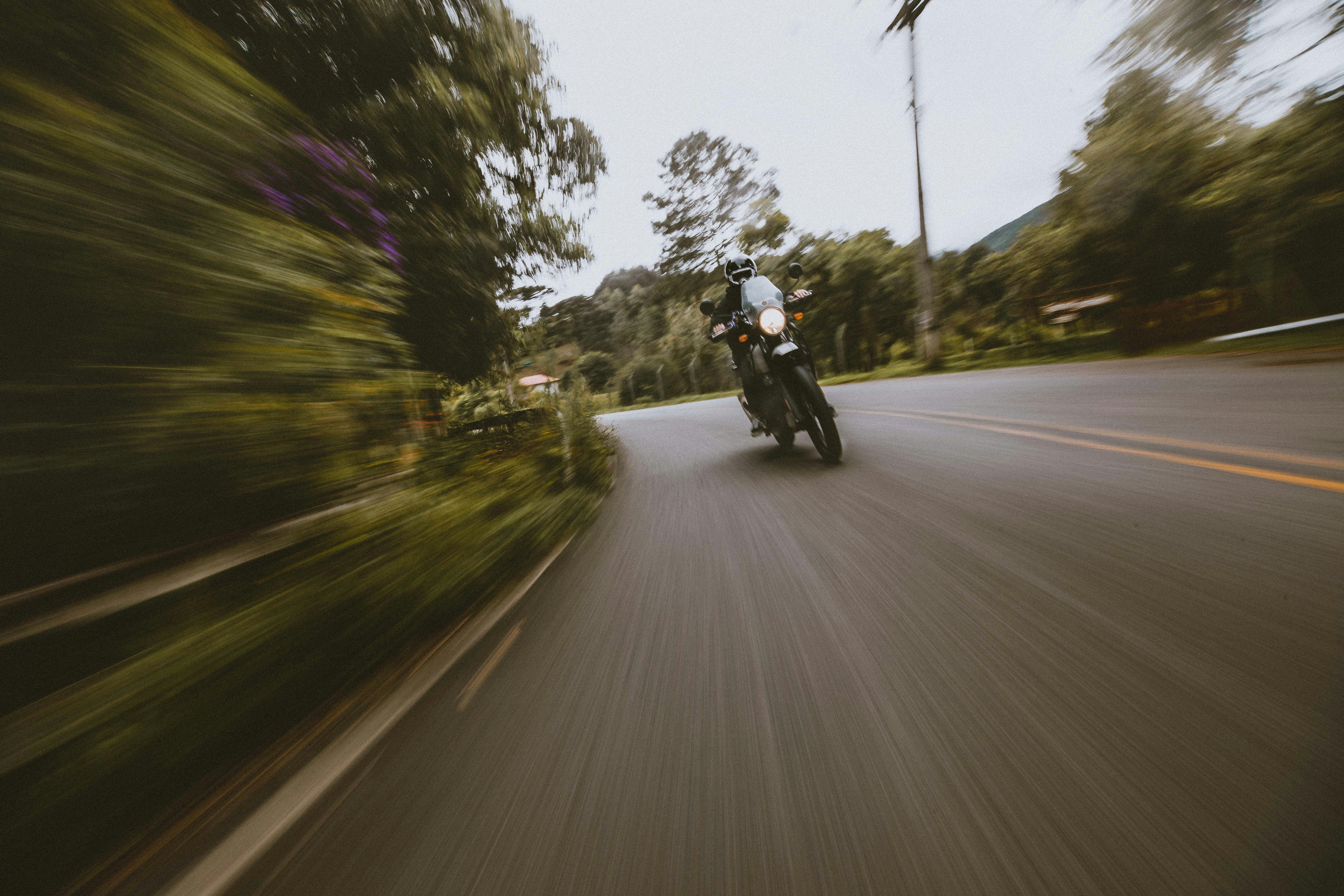 man riding motorcycle on road during daytime